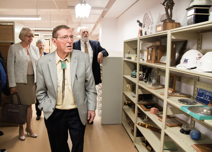 Senator Pete V. Domenici is walking and reviewing NMSU archive items