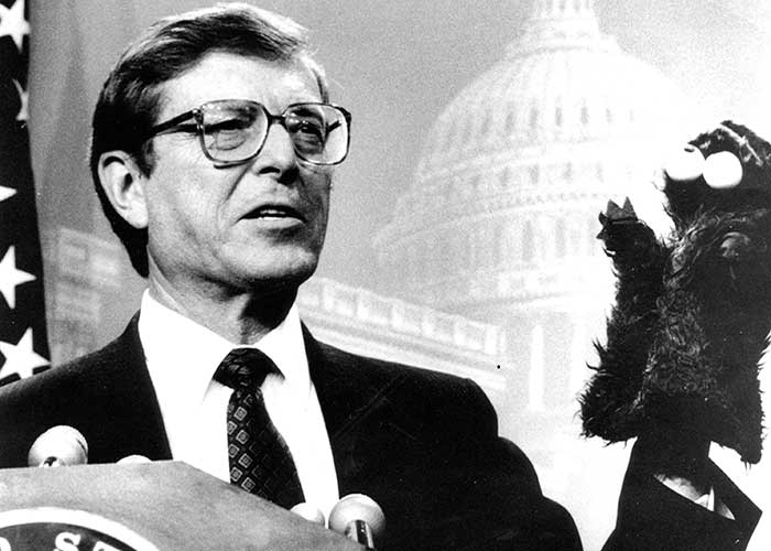 Black and white picture of Senator Domenici with Cookie Monster puppet